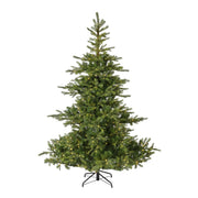 A pre-lit artificial Christmas tree with green needles and warm yellow lights, mounted on a black metal stand against a plain white background.
